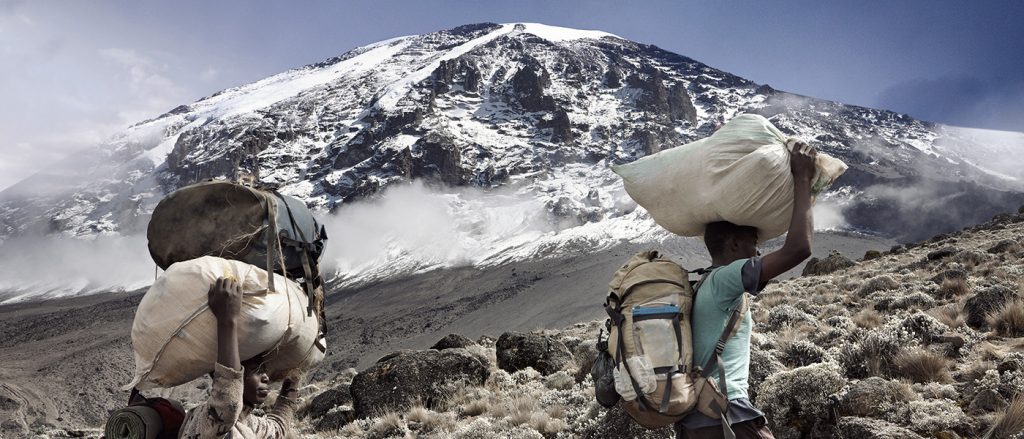 porters walking up kilimanjaro